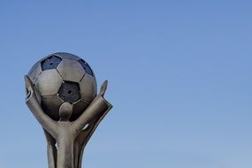 sculpture of a man holding a ball