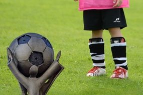 young football player in kick shoes