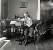 black and white photo of a man working at the telegraph