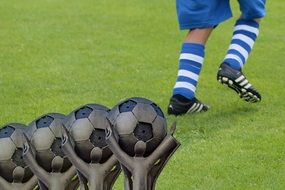 Football rewards against the background of footballer's legs
