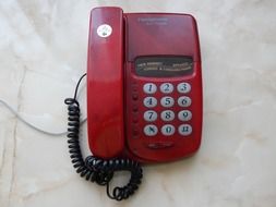 red retro telephone with white buttons