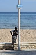 young man with a mobile phone on the coast