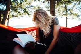 blonde woman reading book read at nature