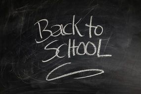 inscription on a blackboard about return to school