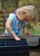 girl planting acorn