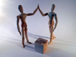 two wooden dolls and puzzle