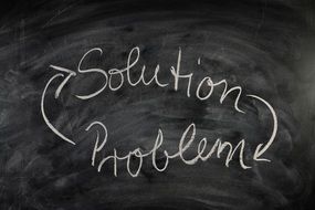 inscription on a blackboard about problem solutions