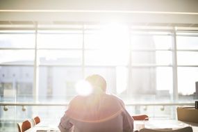 man sitting at the table in the sun