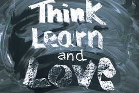 inscription on a blackboard about think, learn, love structure