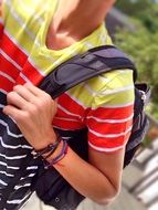 student in a bright t-shirt with a backpack