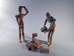 two wooden man build home