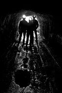 silhouette of people in a coal mine