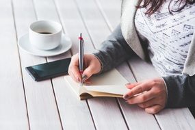 woman making notes in her notepad