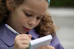 girl writing in a notebook