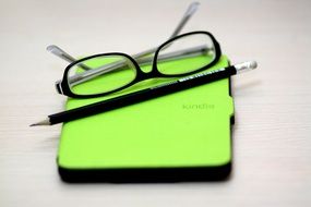 glasses, pencil and eBook