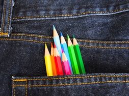 colour pencils in jeans pocket