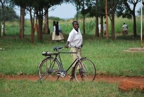 african student with bike in the park