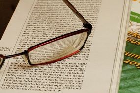 Glasses on the pages of the book