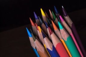 colored pencils on a dark background