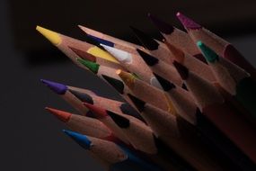 pointed edges of colored pencils in the dark