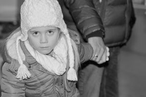 little girl in white cap view winter