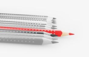 red pencil on black and white background of colored pencils