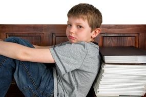 student with a stack of tests for homework