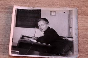 boy at desk in school, old photo