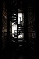 Spiral staircase in a dark corridor
