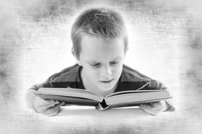 black and white photo of a boy with a book