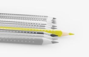 yellow pencil on black and white background of colored pencils