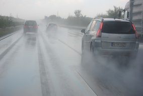 cars go on a wet track in the rain