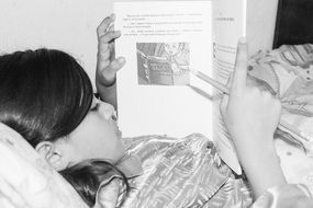 girl reading in bed