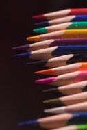 sharpened edges of colored pencils on black background