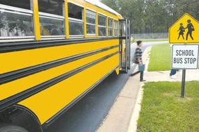boy getting off the school bus