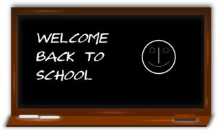 back to school, chalk lettering and smiley on black board, illustration