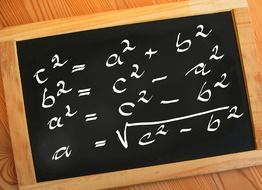 mathematics formulas written with chalk on black board