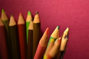 colorful pencils pink wall