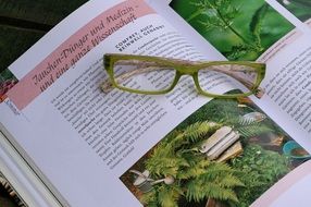 green glasses on the book