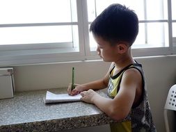 asian child writes