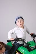 little boy on a kids motorcycle