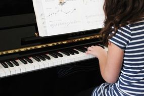 girl playing on piano instrument