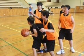 boys play basketball at school