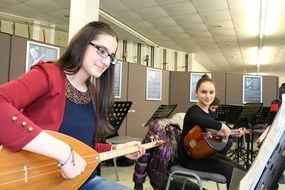 girls with musical instruments in music lesson