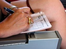 woman solving a crossword puzzle sudoku