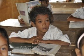 photo of an african american boy at his desk at school