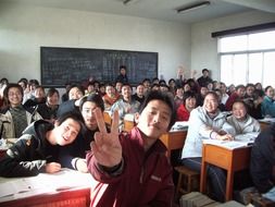 happy asian students in classroom