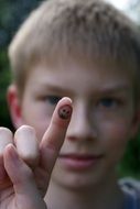 Child is showing the finger with the smile