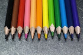 colored pencils at grey background