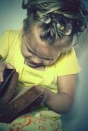 the girl looks into an old book